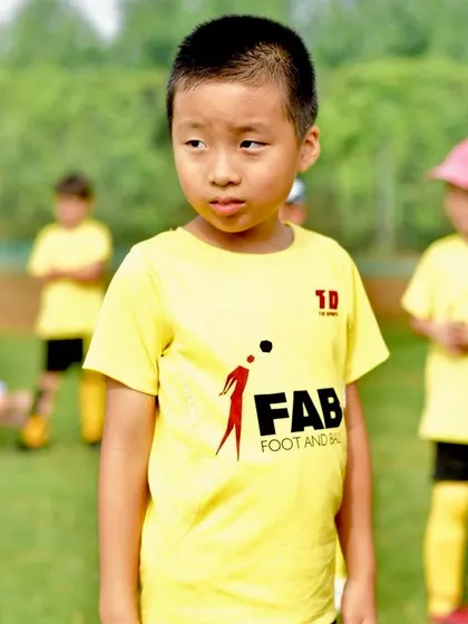 A young player's focused expression during a game. Our training helps nurture well-rounded athletes who are prepared for the challenges of competition.