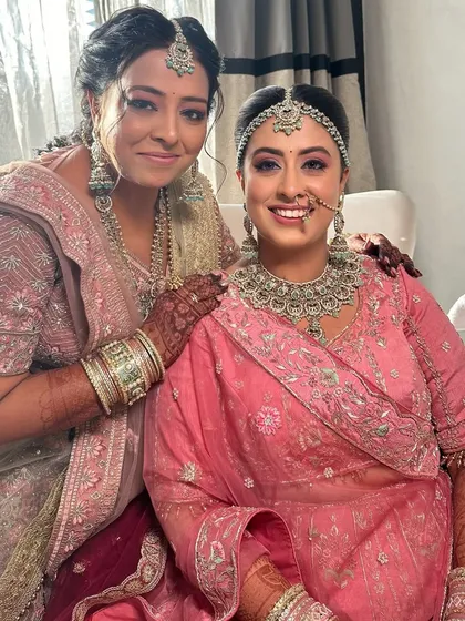 A precious moment with my niece and her sister. Both are styled with complementary makeup that enhances their features for the wedding ceremony.