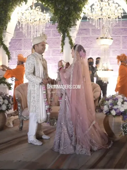 The Jaimala ceremony for Rohan and Ashima, set against a backdrop of Greek inspired architecture and lush greenery. Our planning ensures that every ritual is framed by beautiful, meaningful decor that reflects the couple's story.