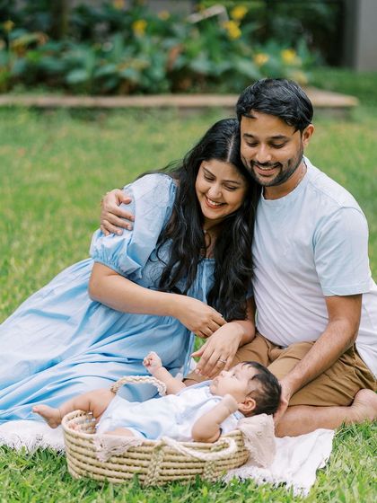 A family picnic with their newborn. Outdoor newborn sessions can be beautiful and serene, especially in a familiar green space.