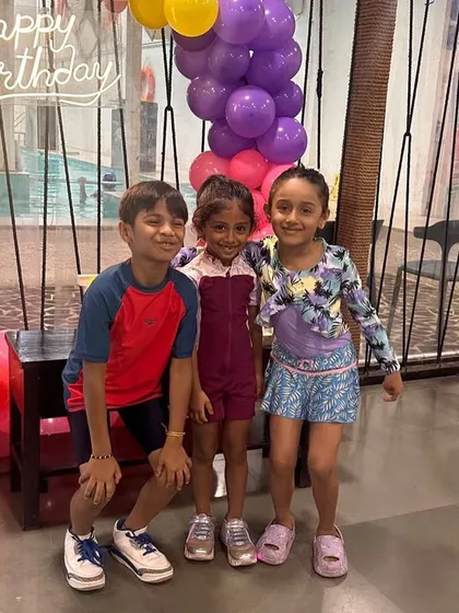 Three happy friends posing for a picture in front of the birthday decorations. Our venue is full of Instagram-worthy spots.