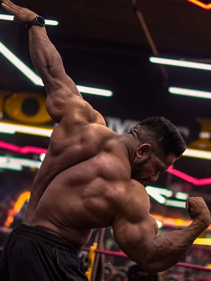 Building a championship-winning back requires hitting it from all angles. This iconic pose shows the width and thickness that we develop through countless hours of pulling and rowing.