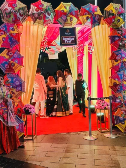 An entrance arch for a Dandiya Night or Mehendi party, decorated with colorful Rajasthani umbrellas. This setup creates a fun and festive welcome for guests.