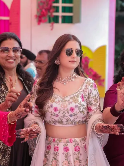 The bride dancing with her family, her outfit allowing for easy movement and celebration.