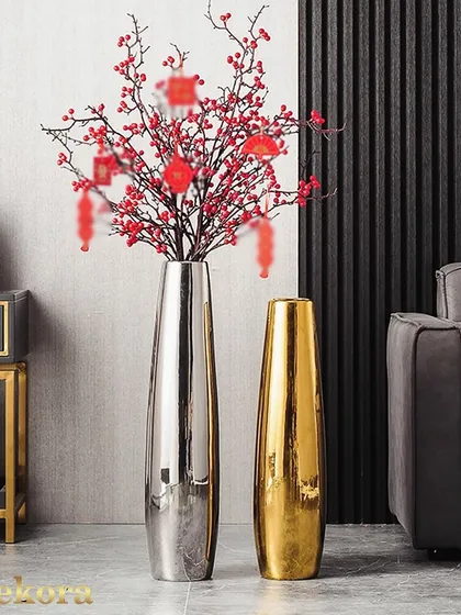 Our tall, reflective metal vases add a touch of modern luxury to your home. Available in polished silver and gold finishes, their sleek, elongated shape is ideal for holding long-stemmed branches or standing alone as a sculptural art piece.