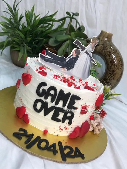 Who says bachelorette cakes can't be elegant and funny? This 'Game Over' cake was so much fun to create, featuring a humorous topper, the wedding date, and red heart details.