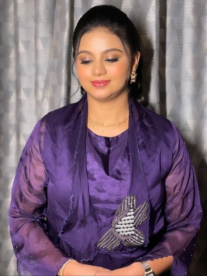 A serene shot with eyes closed, showcasing the delicate eyeshadow work.