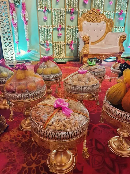 Attention to detail is key. For this Seemantha, we arranged platters of premium dry fruits and sweets on gold-toned stands, wrapping them beautifully to be presented as offerings.