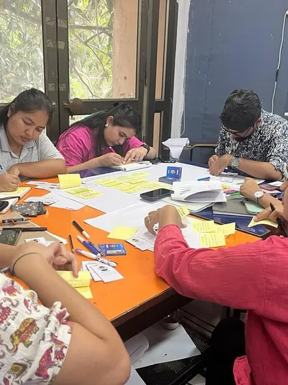 Students from the School of Planning & Architecture New Delhi are deeply focused during an intensive workshop on urban policy. They are using cards and notes in a game designed to simulate urban regeneration challenges.