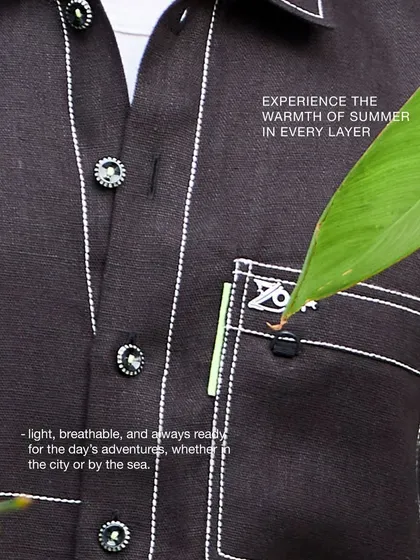 Experience the warmth of summer in every layer. This close-up shows the detailed stitching and breathable fabric of a shirt from the Antriksh collection.