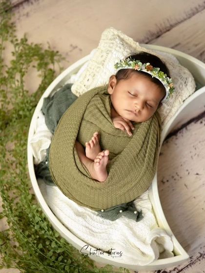 A wider shot of the moon prop setup, showing the delicate greenery accenting the scene.