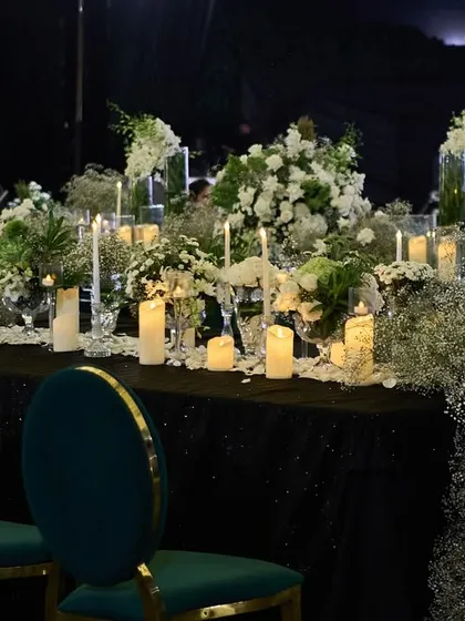 A long table setting for a Sangeet, with a dense runner of baby's breath and candles, creating a dreamy, cloud-like effect.