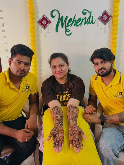 Two of our artists with a satisfied bride. We work as a team to complete even the most elaborate designs efficiently.