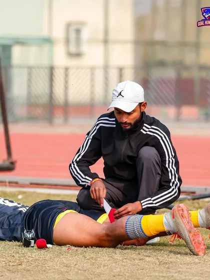 A coach tending to a player's injury on the sidelines. We take care of our own.