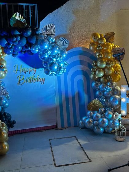 This photo shows the setup ready for a performance or speech, with a microphone stand positioned in front of the stylish backdrop.