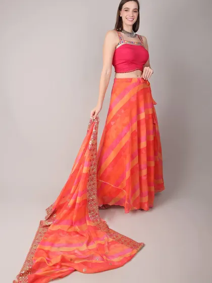 The model displays the full length of the flowing dupatta, which adds an element of drama and elegance to the outfit.
