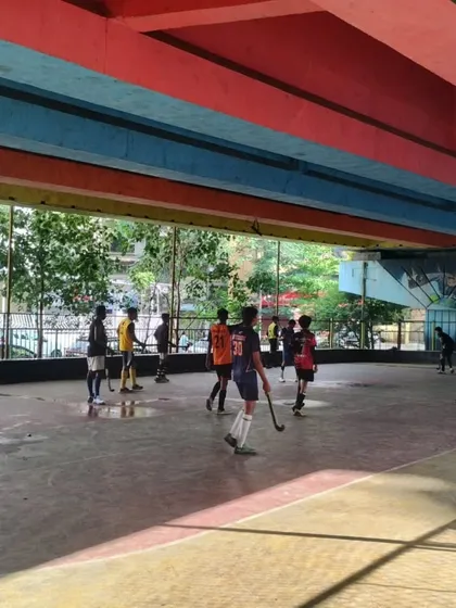 A wide shot of our Sunday practice with junior players at our Sanpada facility. The urban setting under the flyover provides a unique and dynamic training environment.