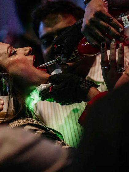 Our team gets right in the middle of the party to serve drinks. A bartender pours a shot for a guest, ensuring the energy never drops.