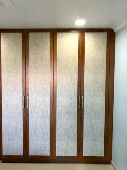 The exterior of our classic Cane Door Wardrobe, installed in a Mumbai home. The combination of natural cane and dark wood brings elegance and functionality together seamlessly.