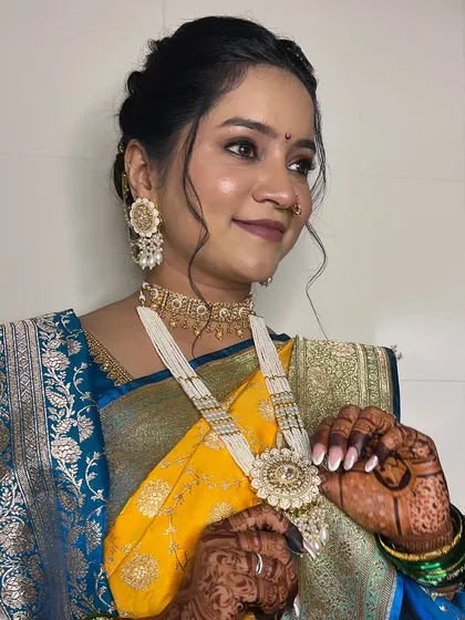 This shot highlights the detailed jewelry and the flawless makeup application.