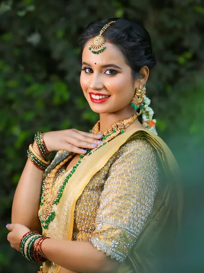 Add a touch of colour to your Muhurtham look with our green stone temple jewellery. This set beautifully complements traditional silk sarees and is a favourite among our brides in Bangalore.