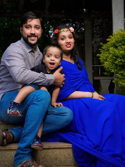 A relaxed family portrait on a set of park stairs. Including older children in the maternity shoot is a wonderful way to make them feel part of the special journey.