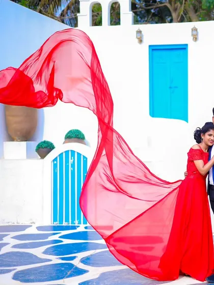 A beautiful shot capturing the bride's flowing red gown against the white and blue of our Santorini-inspired location.