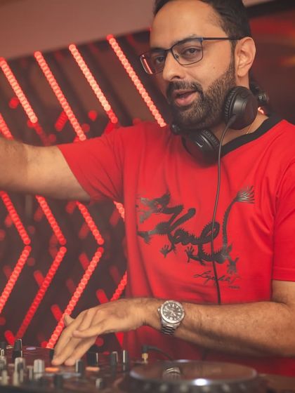 Focused on the mix. A close-up shot of me at the Pioneer controller, ensuring every transition is seamless and keeps the party's momentum going.