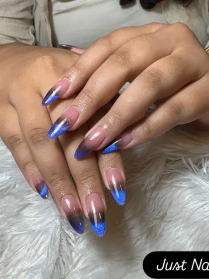 A dramatic cat-eye ombre effect. This design transitions from a nude base to a black tip with a vibrant blue magnetic shimmer.