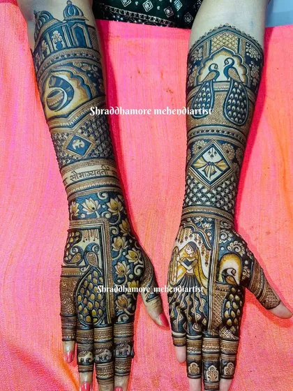 This custom design features a bride in a dancing pose on one palm and a majestic peacock on the other. The arms include a horse-drawn carriage and the auspicious 'Shubh Vivah' message.