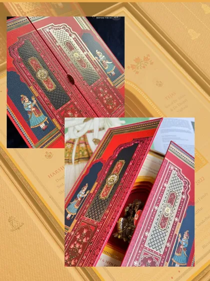 A rich, red boxed invitation with traditional Indian motifs, opening up to reveal the beautiful details inside. This sets the stage for a grand, royal celebration.