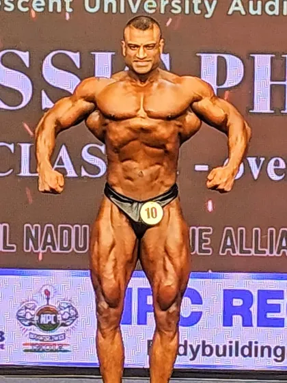 A shot from the NPC Nationals stage in Chennai. This front relaxed pose shows the V-taper and abdominal control that I emphasize from day one with my clients.