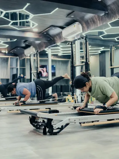 The energy in our group Reformer classes is motivating. Here, clients are synchronized in a leg and core exercise, building strength together while maintaining individual focus and form.