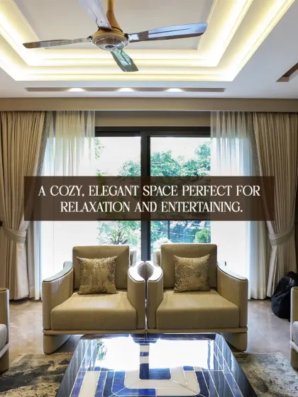 A cozy, elegant space perfect for both relaxation and entertaining. The large window allows for abundant natural light, while the unique armchairs and statement coffee table add a touch of modern design.