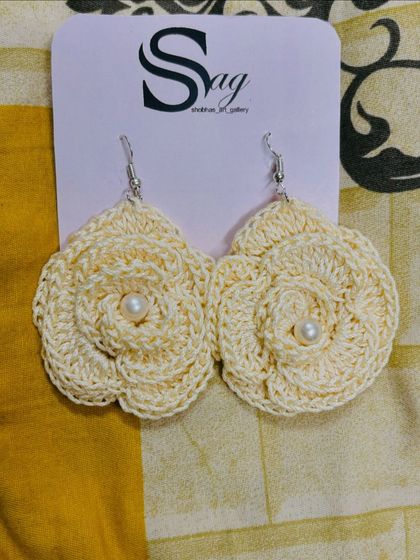 This pair of off-white rose crochet earrings shows the detailed, layered petal work. These handmade earrings are perfect for a classic, understated look.