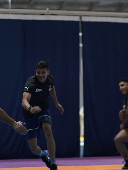 Trying to evade a 'tackle' from one of the players. It's all in good fun.