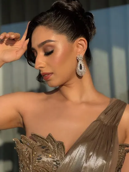 A portrait that captures the sophisticated vibe of the cocktail look. The makeup is sculpted and defined, ensuring it looks stunning in the low light of an evening event.