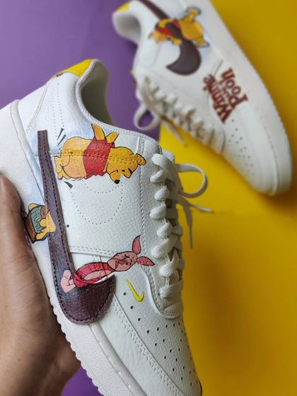 A side view of the Winnie the Pooh custom Nike Court Visions.