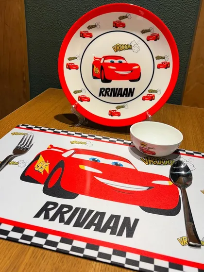 Another look at our 'Cars' themed kids' meal set. This shot highlights the personalised placemat and plate, designed to make eating an adventure.
