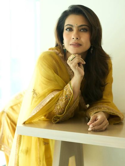 A portrait of Kajol in the yellow salwar kameez, highlighting the intricate gold embroidery on the sleeves and dupatta.