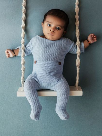 Monday blues with this cute little champ. A more playful setup with a baby on a tiny swing, showing a creative option for slightly older newborns.