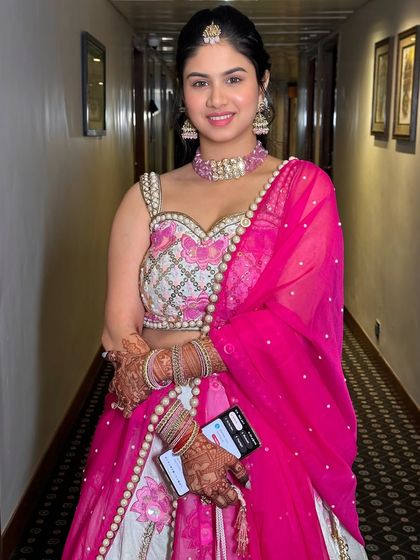 The full look, showcasing the beautiful pink and white lehenga and the complementary minimal makeup.