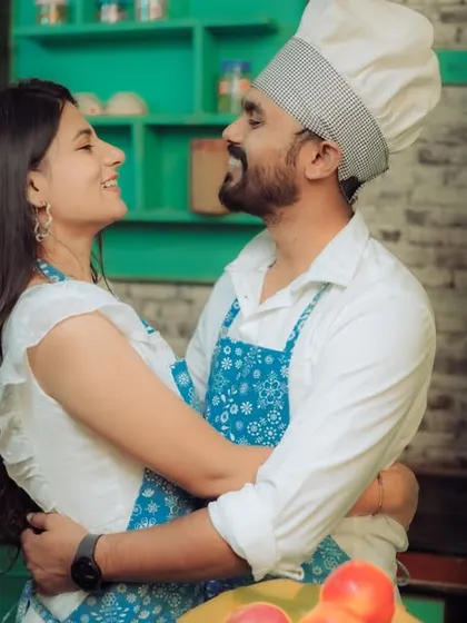 Love is cooking up something beautiful! This couple shares a laugh in a quirky kitchen setting, a perfect example of a themed pre-wedding shoot that reflects shared interests and creates fun, natural interactions.