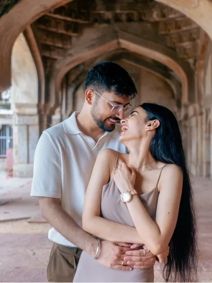 Sharing a laugh inside the arched hallways of a historic monument. This candid moment showcases the couple's joyful connection, a key element I focus on in my engagement photoshoots.