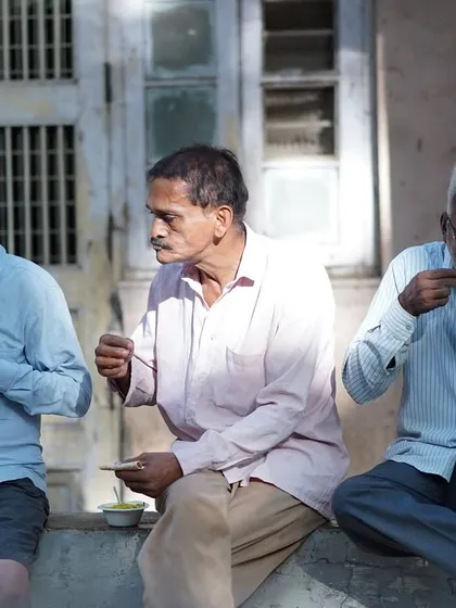 Three men sharing a meal and a moment of rest. Our initiative provides not just sustenance but also a space for community and connection.