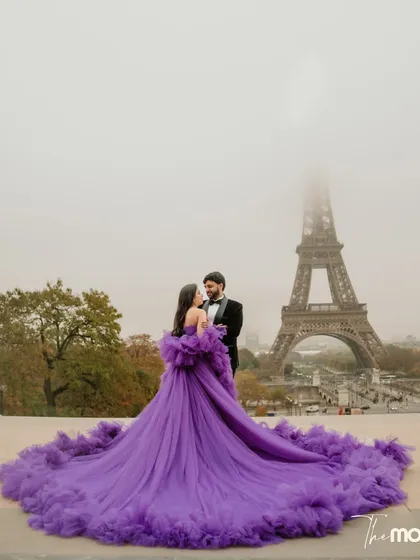 In the heart of Paris, a moment of pure fairytale romance unfolds. The bride's magnificent purple gown flows against the iconic backdrop of a misty Eiffel Tower, creating a frame that is both grand and deeply personal. This is what a destination pre-wedding shoot in Paris feels like.
