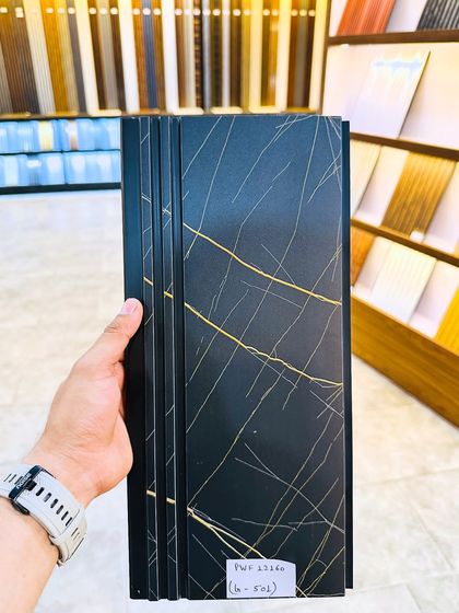 A close-up of the black fluted panel with gold streaks, showing the detail and quality of the finish.