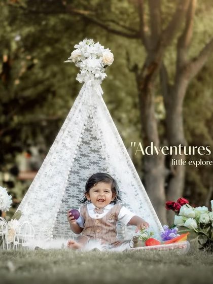 Adventures await with this little explorer. A smiling toddler enjoys her time in our outdoor teepee setup.
