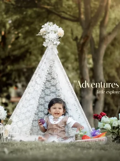 Adventures await with this little explorer. A smiling toddler enjoys her time in our outdoor teepee setup.
