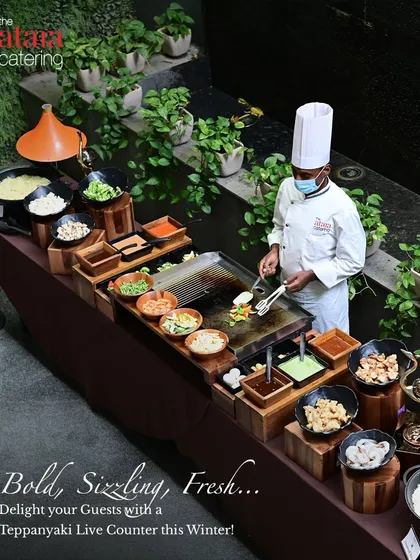 We bring the theatre of Teppanyaki to your party. This high-angle view shows our complete, professional live counter where chefs prepare customized stir-fries with fresh vegetables, proteins, and sauces right before your guests' eyes.